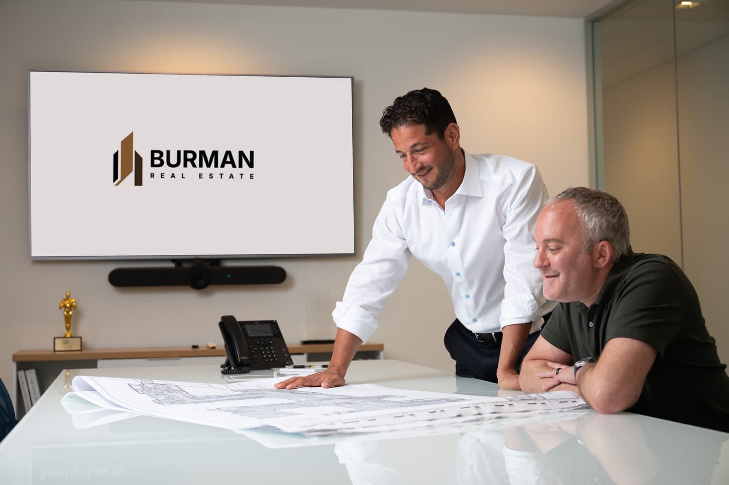Scott Burman and Adam Mann reviewing development plans in the conference room