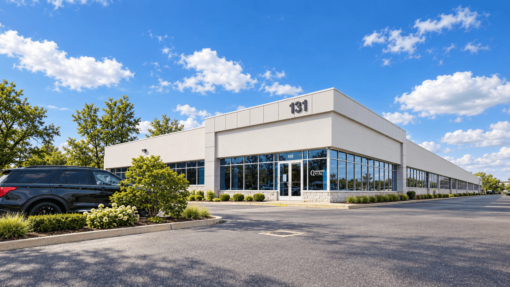 Plainview Commercial Center — single-story flex office building with glass storefront and parking
